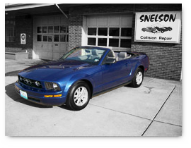 Repaired Mustang in front of Collision Shop